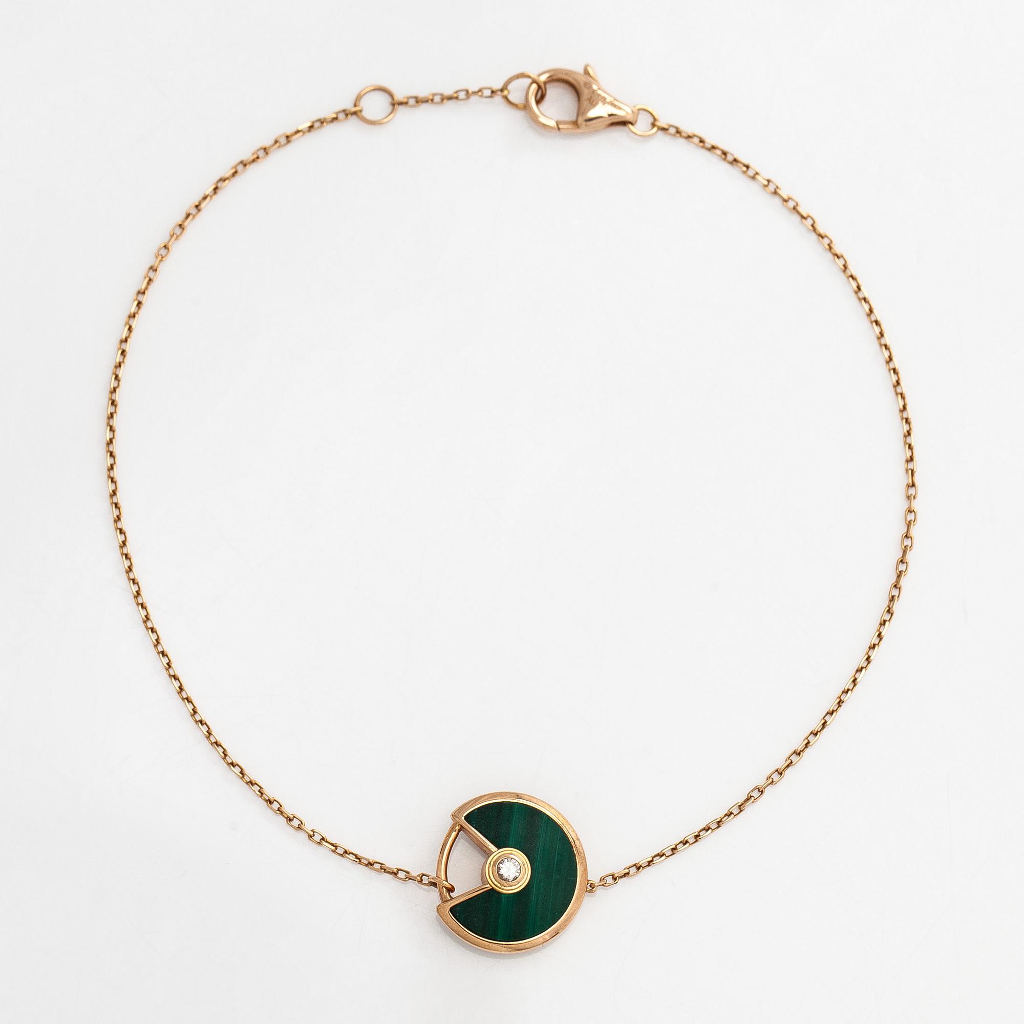 Cartier, an 18K gold "Amulette de Cartier" bracelet with malachite and a brilliant-cut diamond.