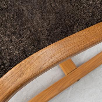 Jan Ekström, a "Gazell" armchair with a footstool, 21st century.