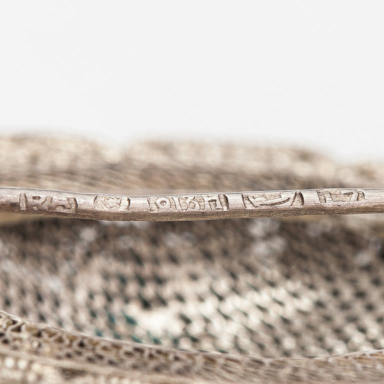 A silver bracelet and ring with turquoises. China.