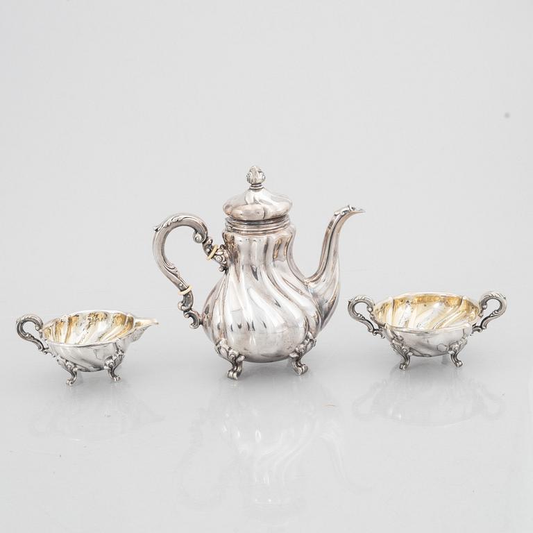 A Rococo Style Silver Coffee Pot, Creamer and Sugar Bowl, 20th Century, Swedish import mark.