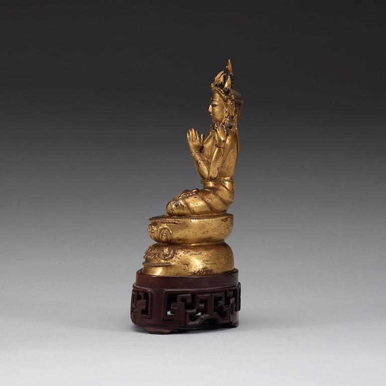 A gilt copper alloy figure of Sukhavati Avalokiteshvara seated on a high lotus base, Tibet, 15th/16th Century.