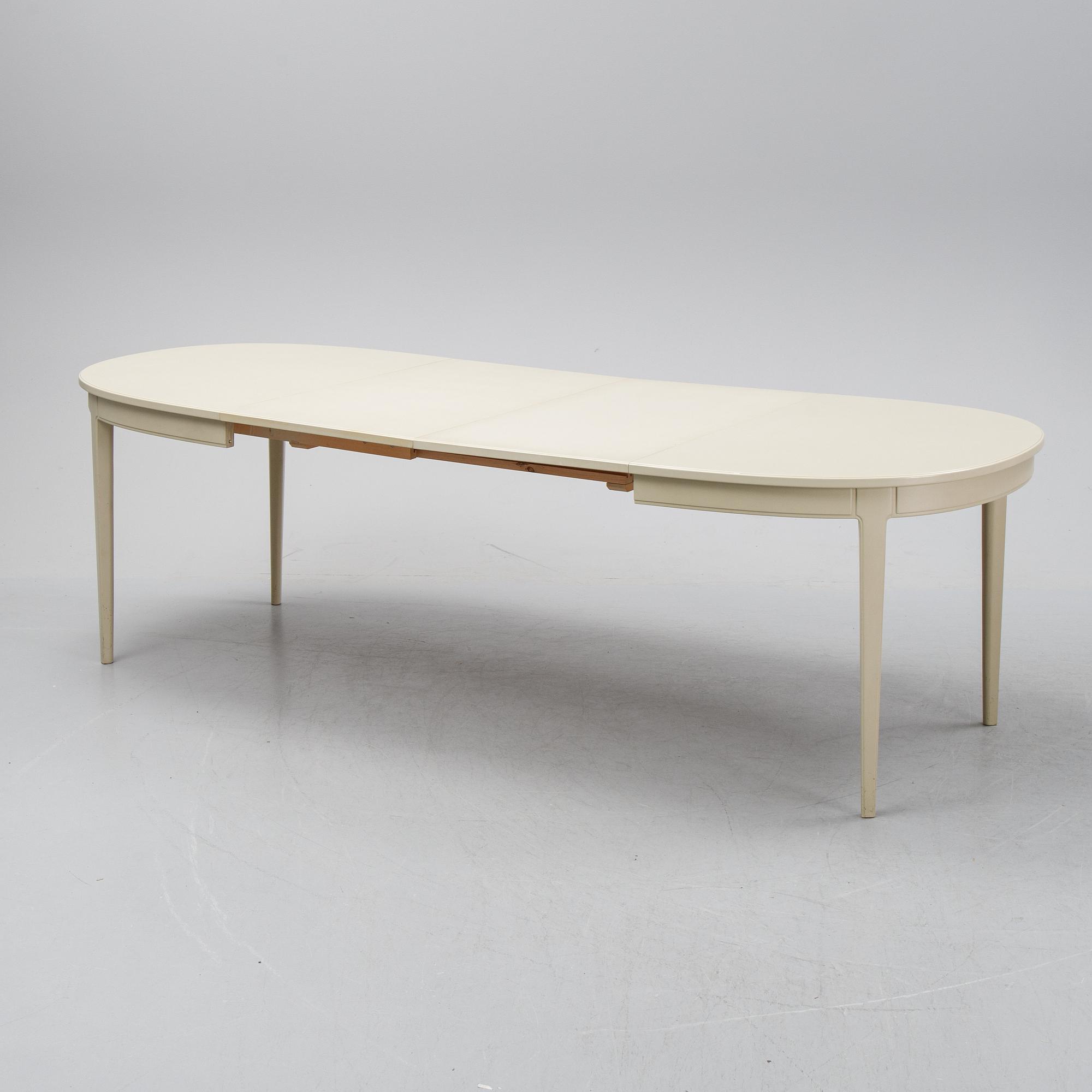 A dining table with six chairs by Carl Malmsten, second half of the 20th Century.