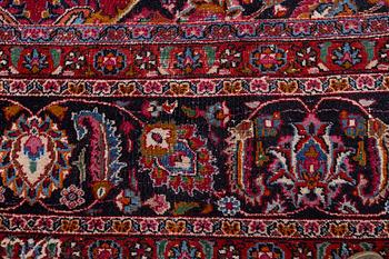 An Oriental carpet, approx. 380 x 304 cm.
