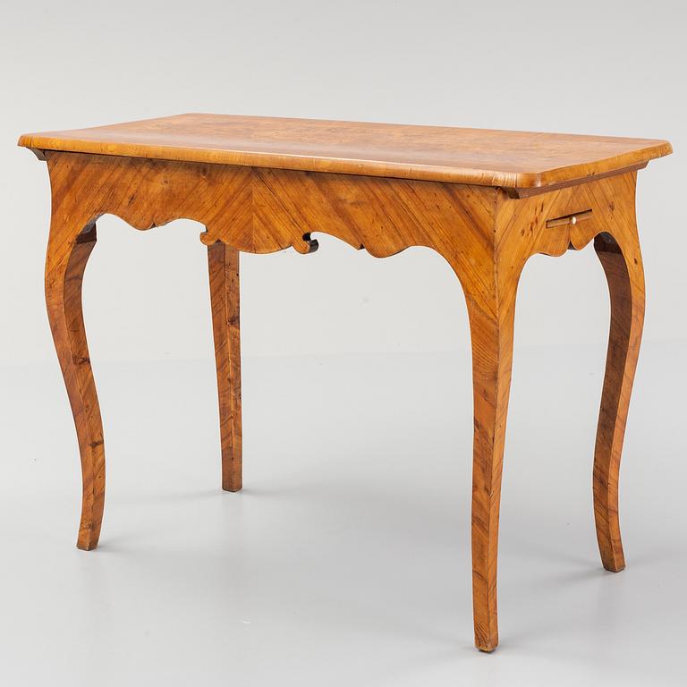 An elm veneered Rococo games table, 18th Century.