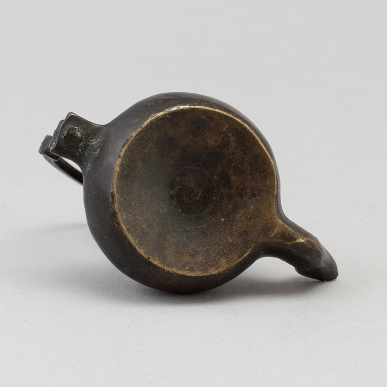 An 18th century bronze oil lamp.