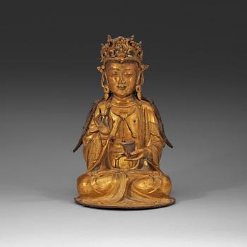 210. A gilt-bronze figure of a seated Guanyin, Ming dynasty (1368-1644).