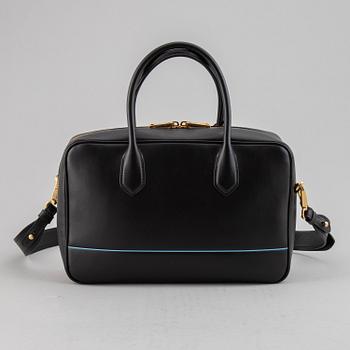 PRADA, a leather bag.