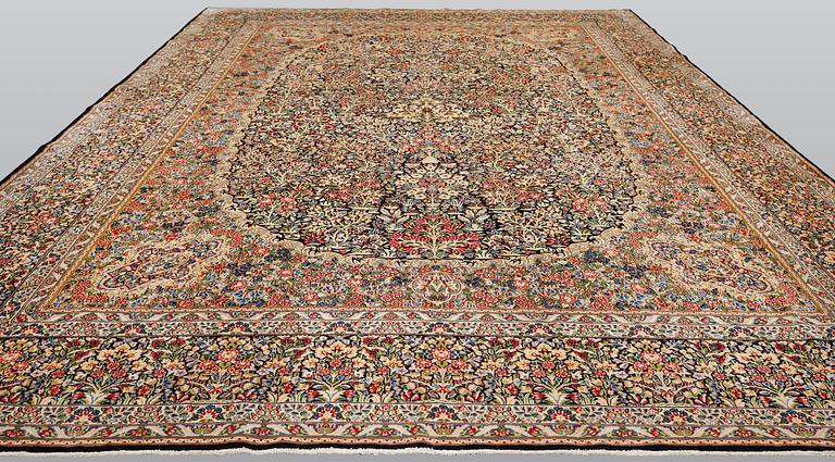 A Kirman Laver carpet, 'Millefleur', approx. 492 x 350 cm.