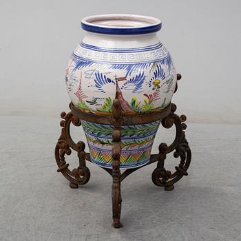 a earthenware urn on iron stand, late 20th century.