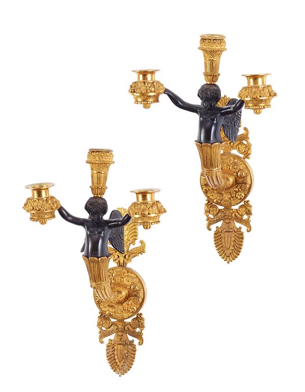 A pair of Empire early 19th century three-light wall-lights.