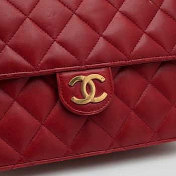 CHANEL, a red leather shoulder bag.