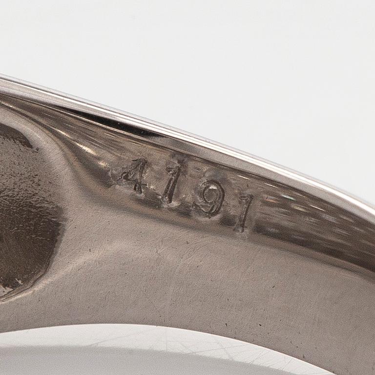 A platinum bombé ring with brilliant-cut diamonds.