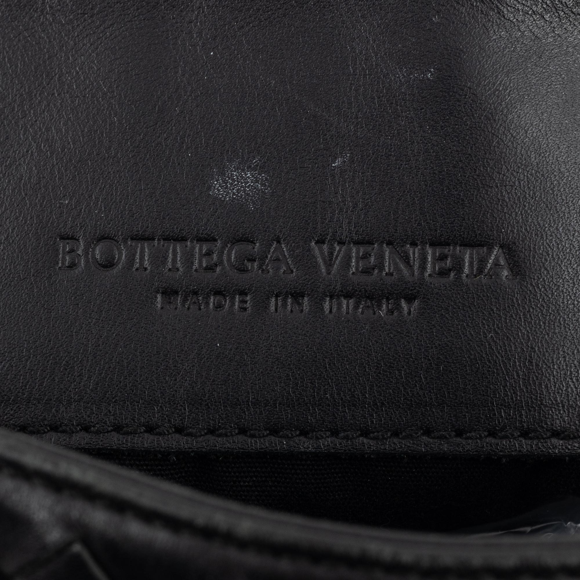 Bottega Veneta, a black intrecciato leather bag.