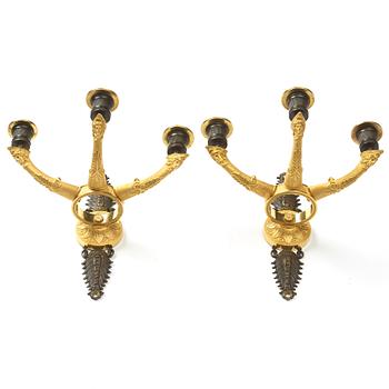 A pair of French Empire three-light wall-lights, early 19th century.