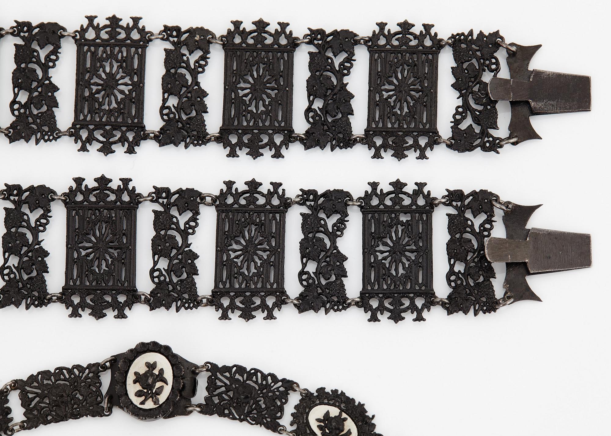 A Berlin steel and iron parure comprising a necklace, two bracelets and a brooch.