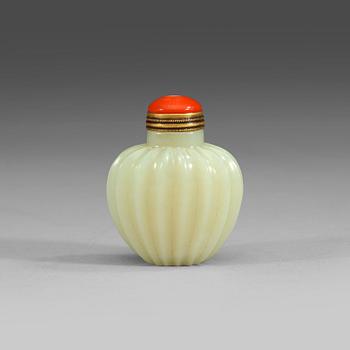 A finely carved nephrite snuff bottle with stopper, China.