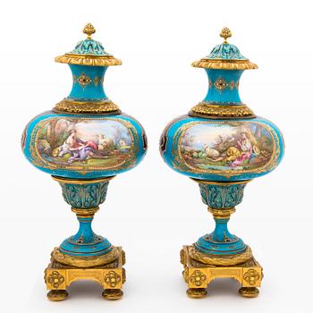 A pair of late 19th-Century porcelain urns, Sèvres-like mark.