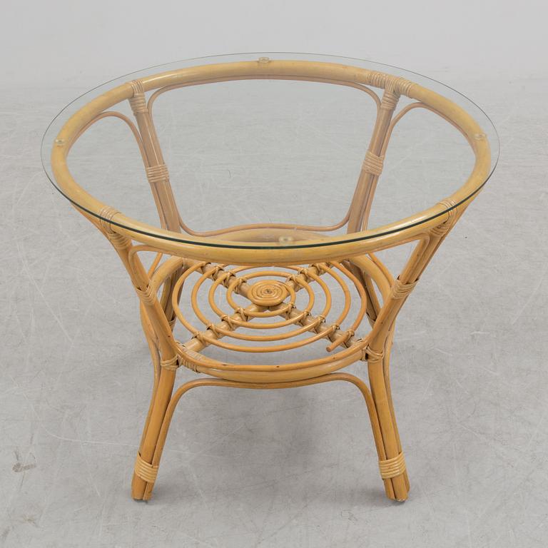 A 1970s four piece set of rattan garden furniture.