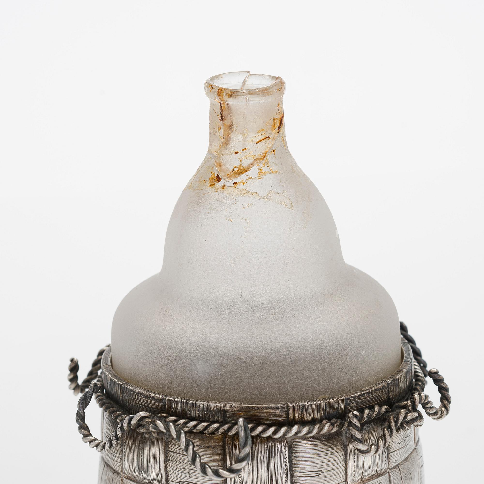 A silver and glass bottle with eight silver charka, maker marks of Pyotr Yermolajevich Davidov, Saint Petersburg, 1884.