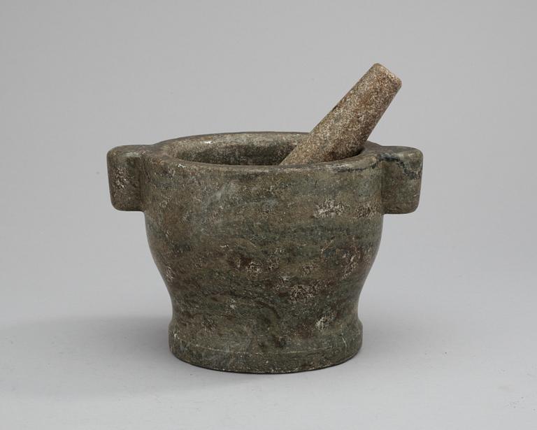 A marble mortar with pestle.