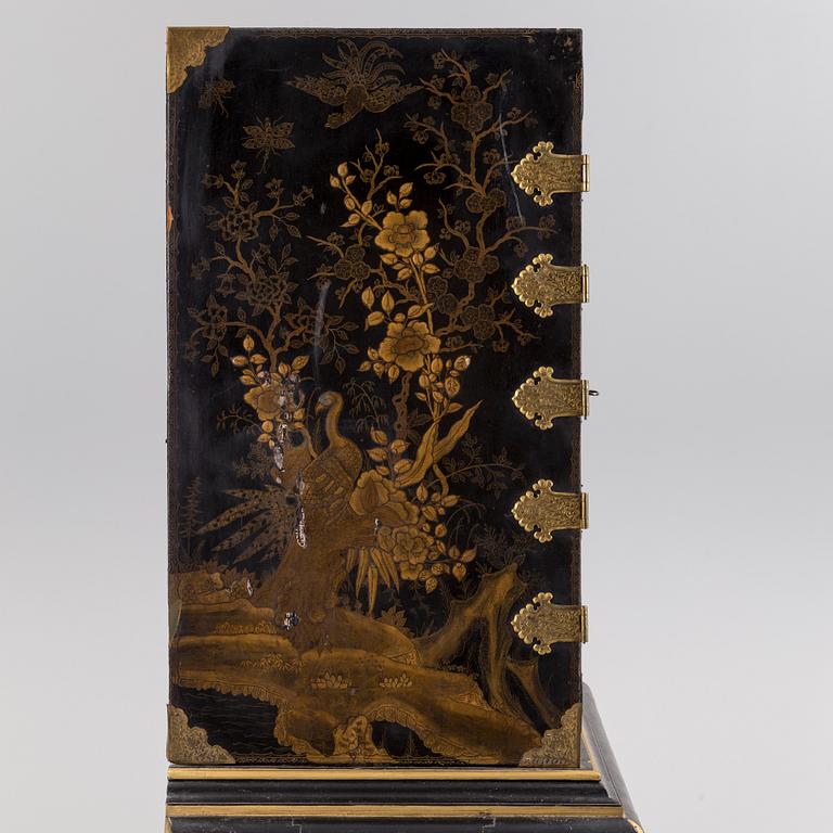 AN early 18TH CENTURY PROBABLY ENGLISH Japanned laquer cabinet on stand.