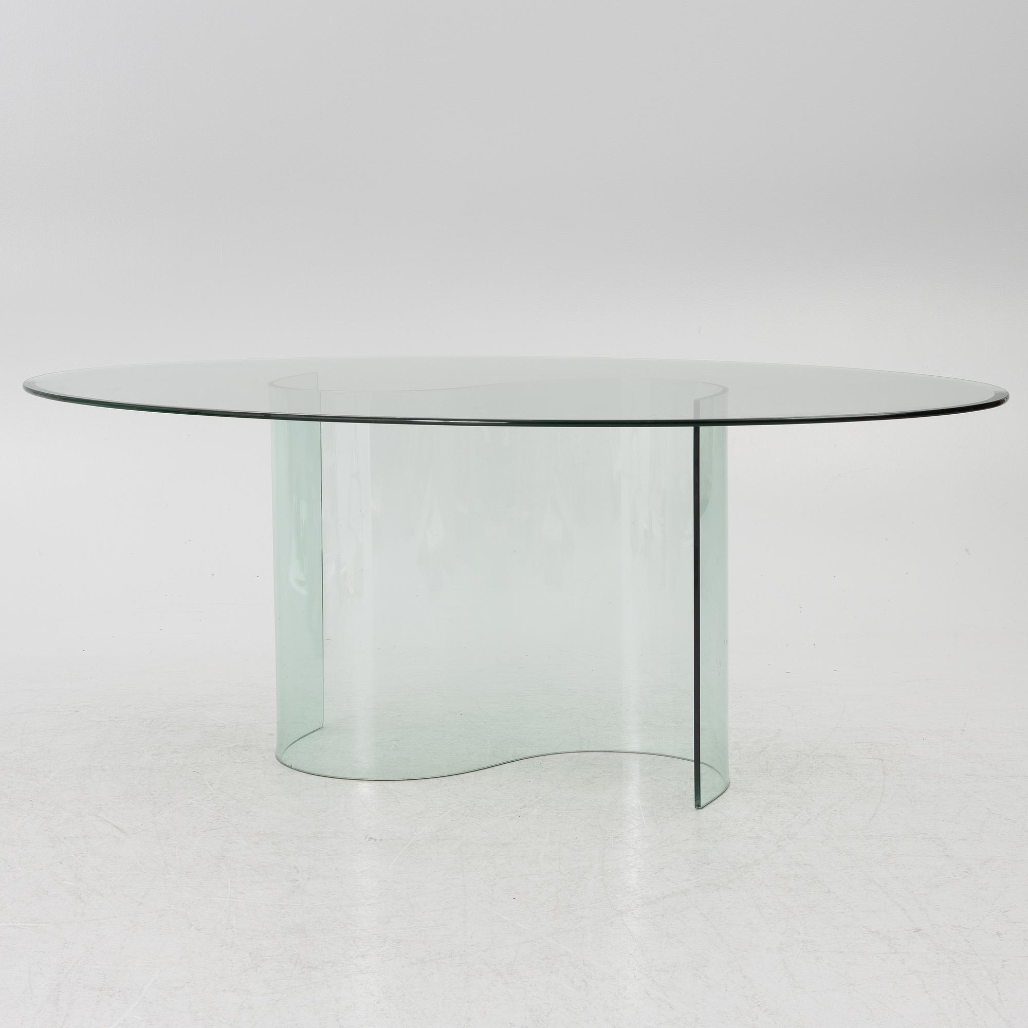 A dining table, glass, contemporary.