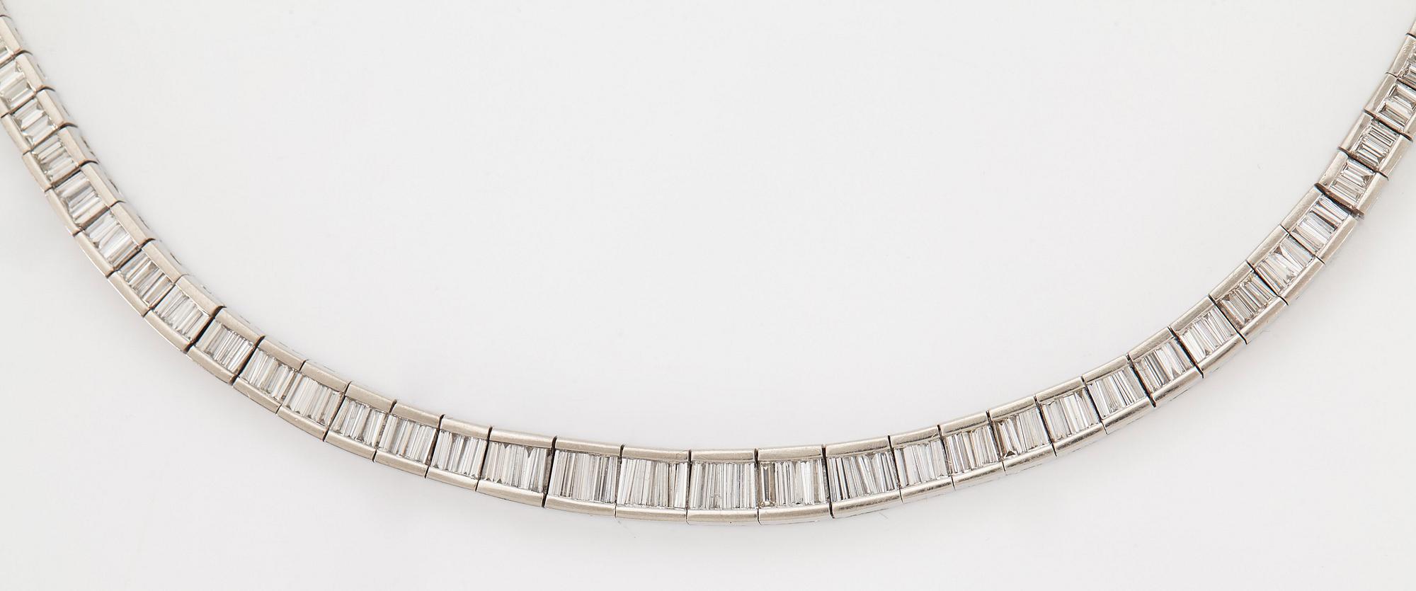 A platinum necklace set with tapered baguette-cut diamonds.