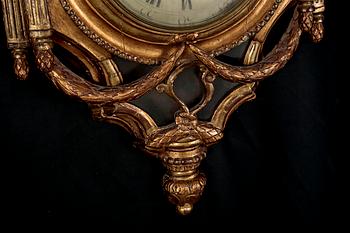A Gustavian wall hanged clock, dial marked "Jacob Kock Stockholm", maded in the second half of the 18th century.
