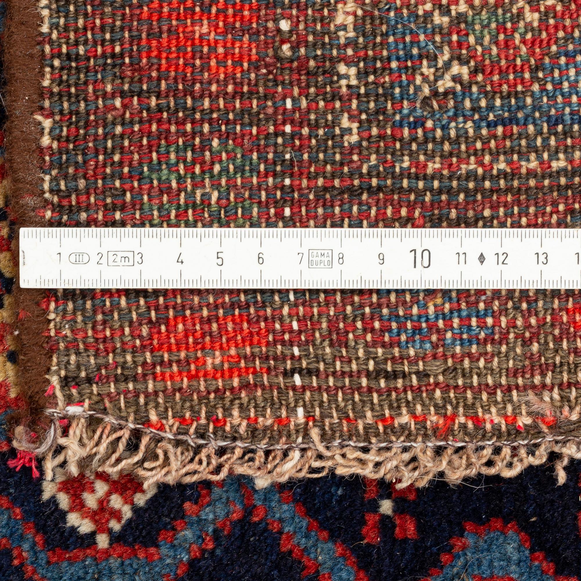 A carpet, semi-antique kurdish, circa 300 x 147 cm.