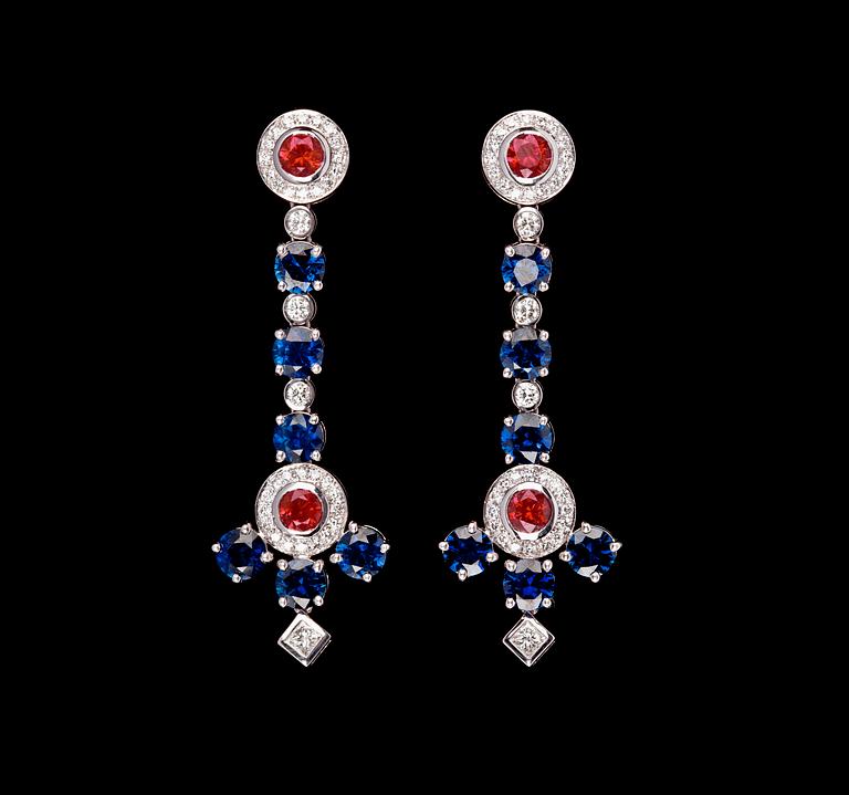 A pair of blue sapphires- rubies and diamond ear pendants.