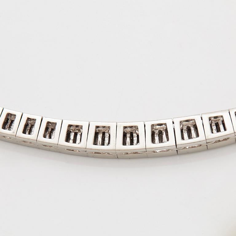 A platinum necklace set with tapered baguette-cut diamonds.