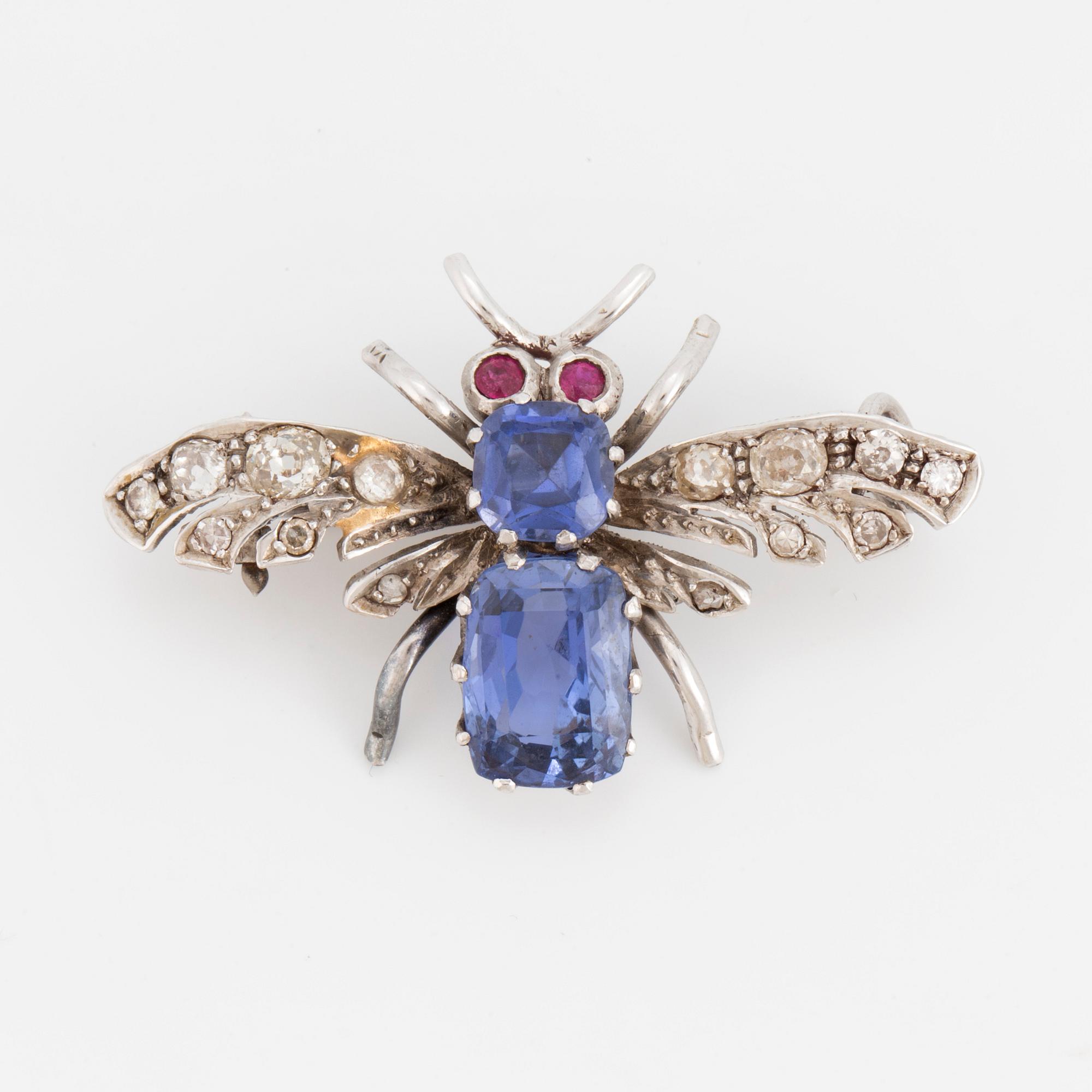 A brooch in the shape of a fly.
