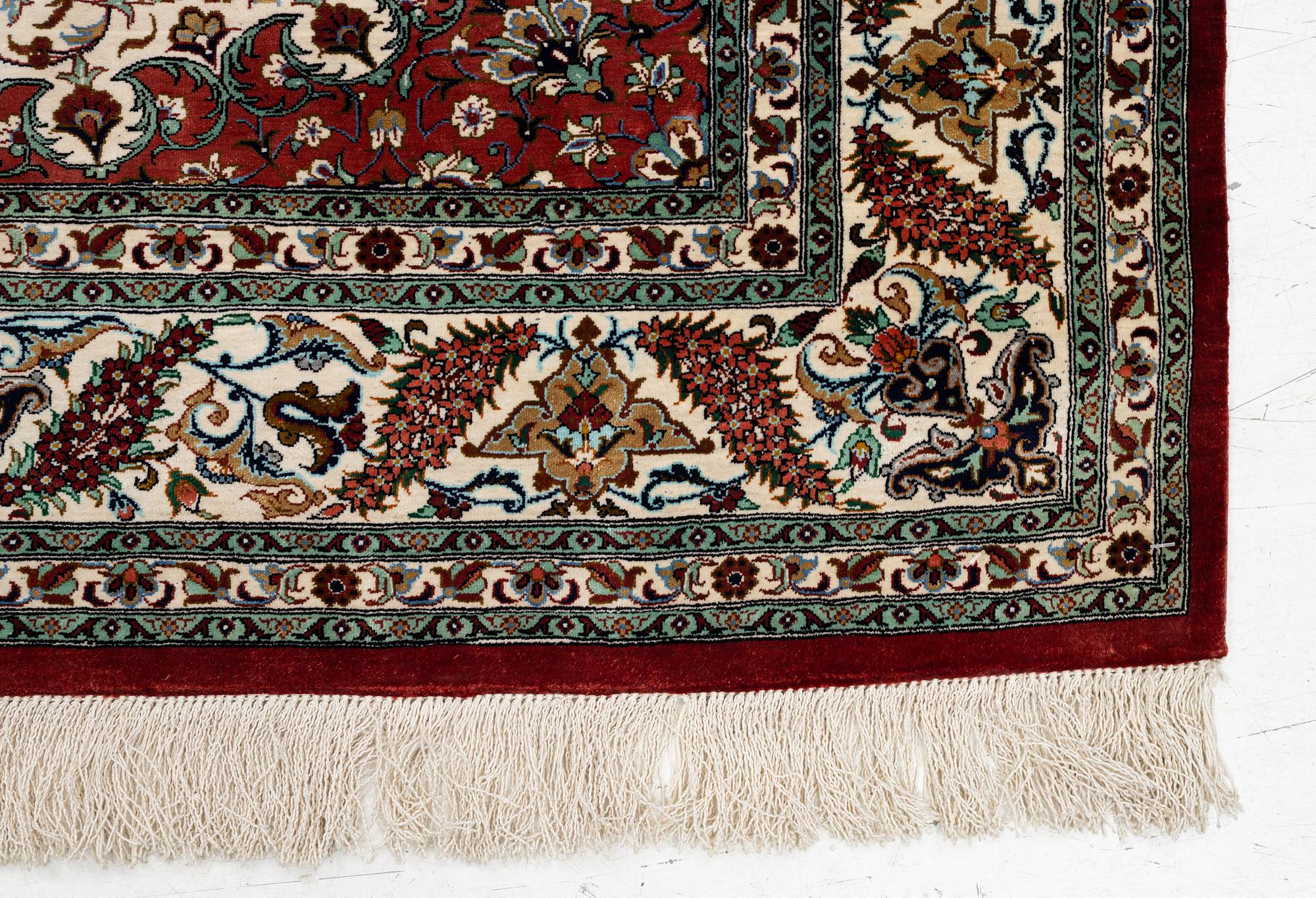 A Ghom silk rug, signed, c. 148 x 100 cm.