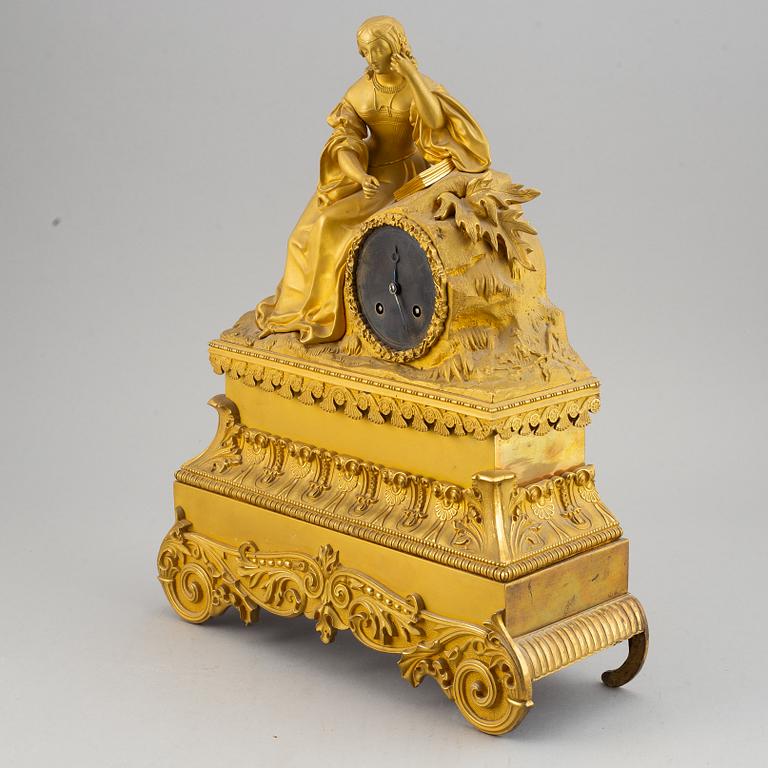 A French gilt bronze mantle clock, mid 19th century.