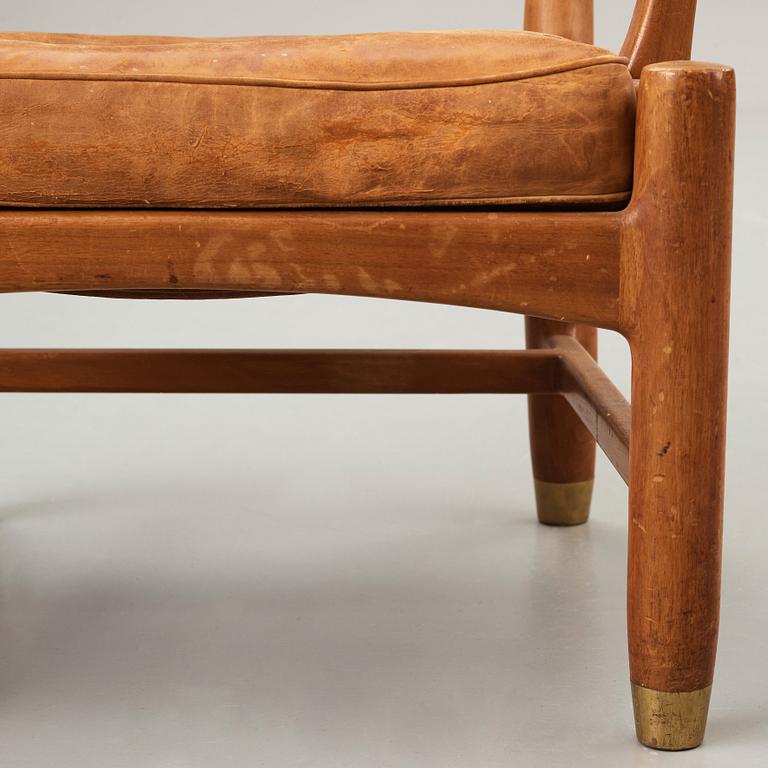 SCANDINAVIAN MODERN, a set of three mid 20th century mahogany and brown leather easy chairs.