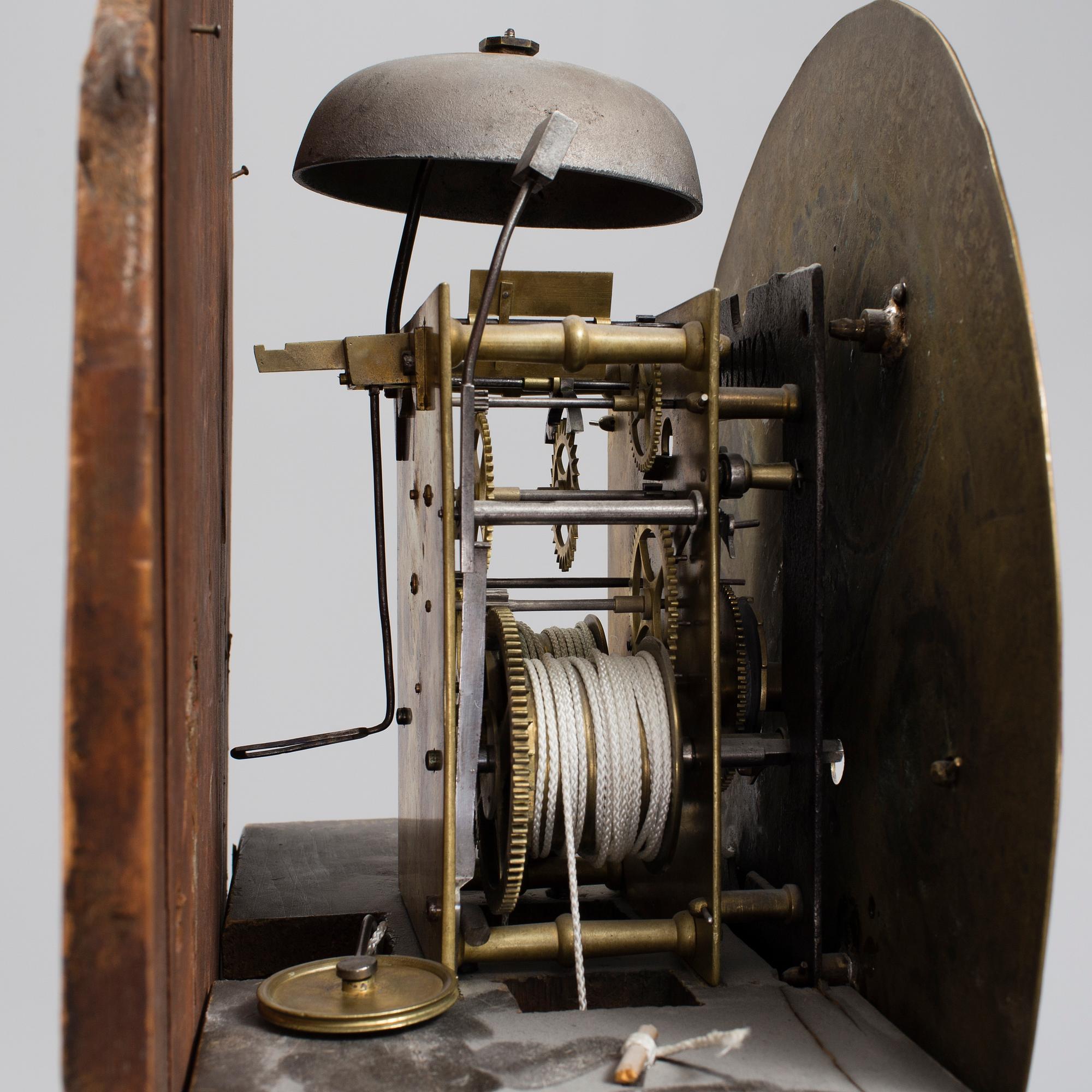 A 19th century Longcase Clock with arched brass dial inscribed Thomas Atkinson, Ormskirk, England.