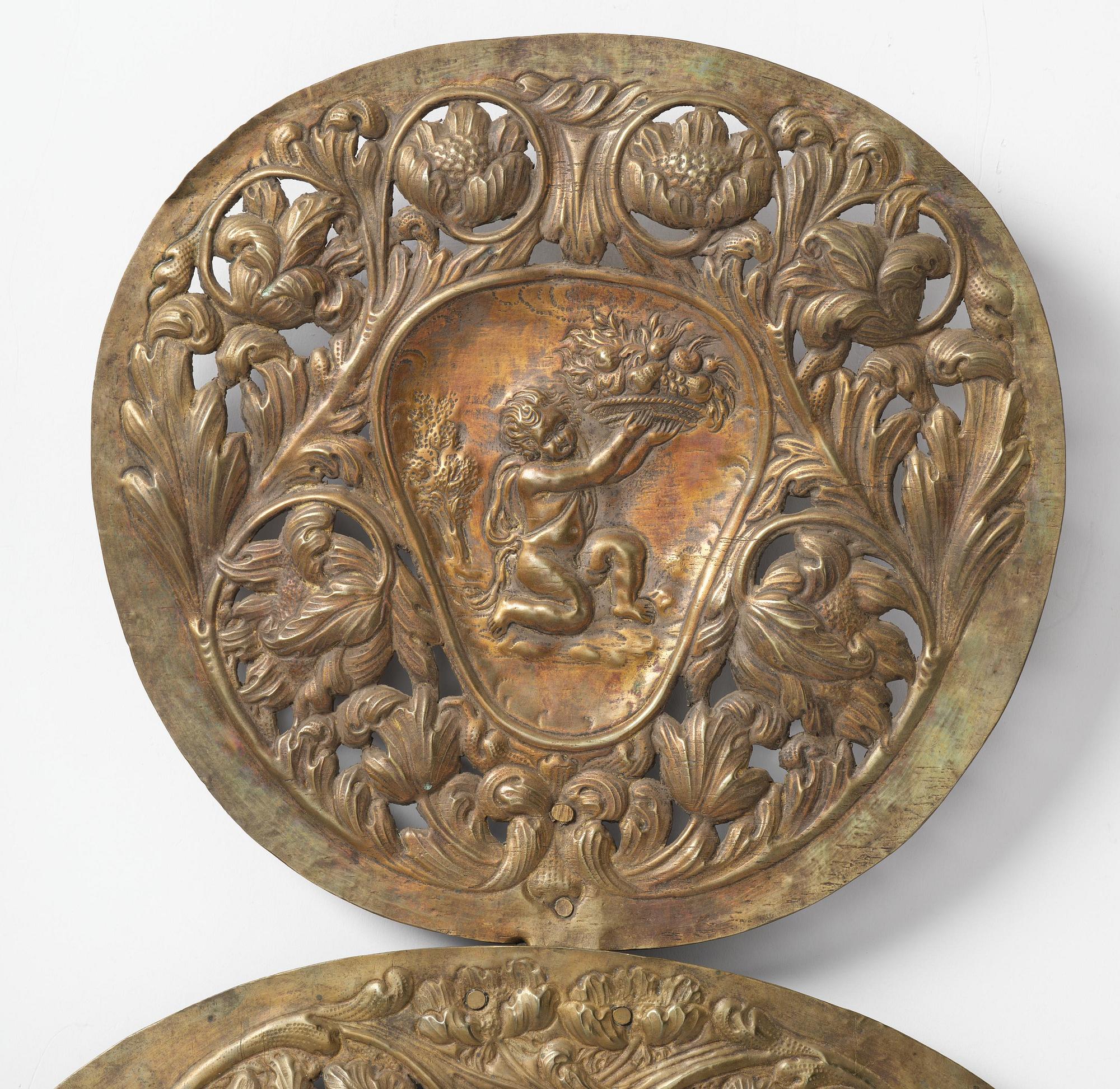 A set of four Swedish Baroque repoussé silvered brass reflector one-branch reflector plates, ca 1690-1700.