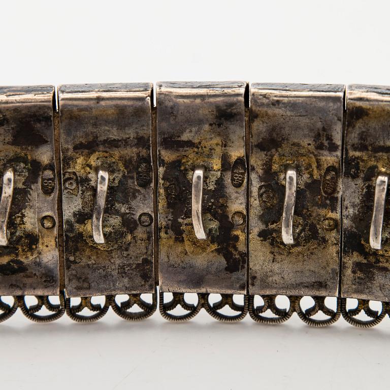 A Caucasian parcel-gilt costume belt with niello decor, 1908-26.