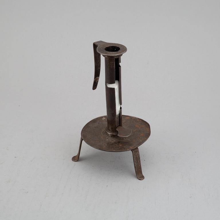 An 18th century cast iron candlestick.