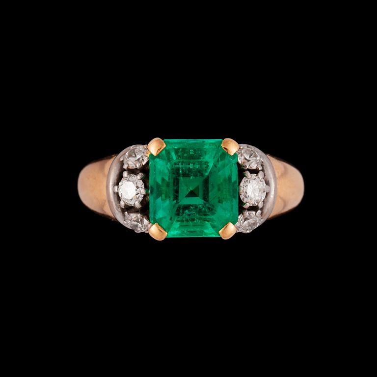 A emerald and diamond ring.