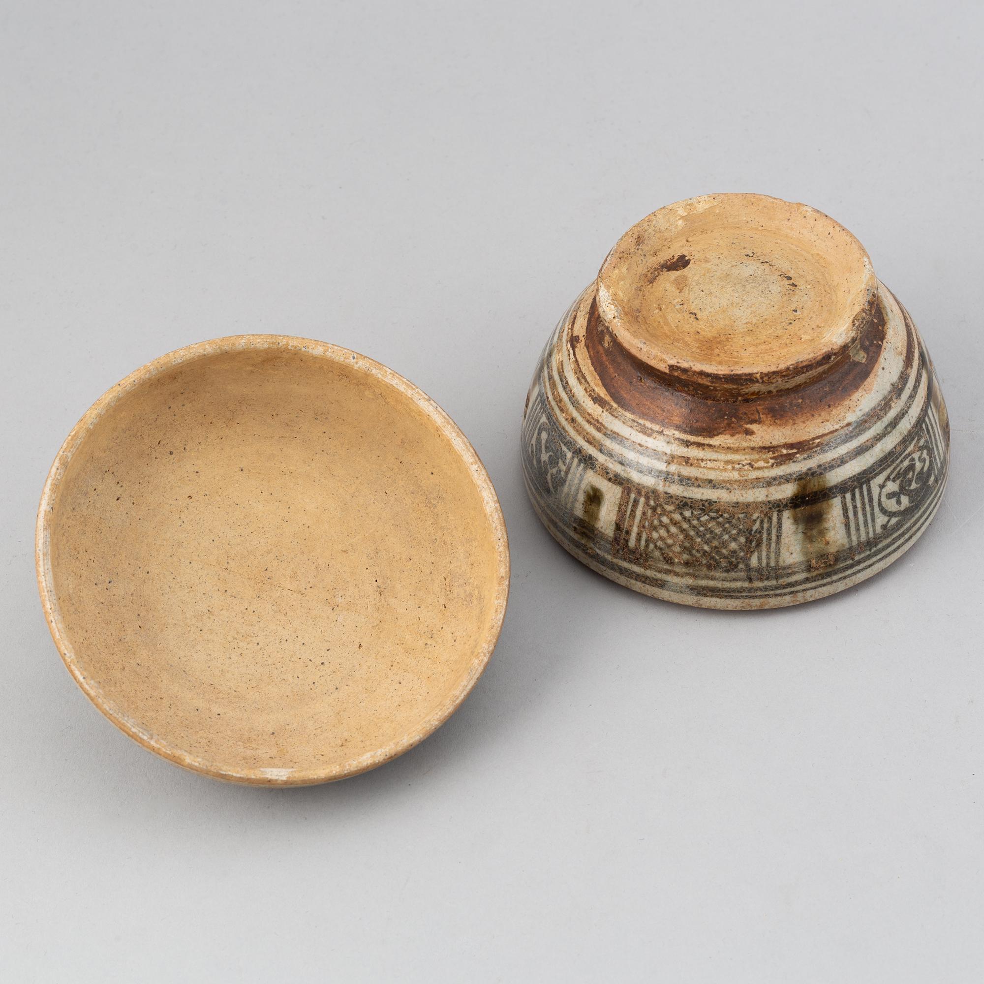 A Sawankhalok jar with cover and a pale celadon glazed bowl for the South East Asian market.