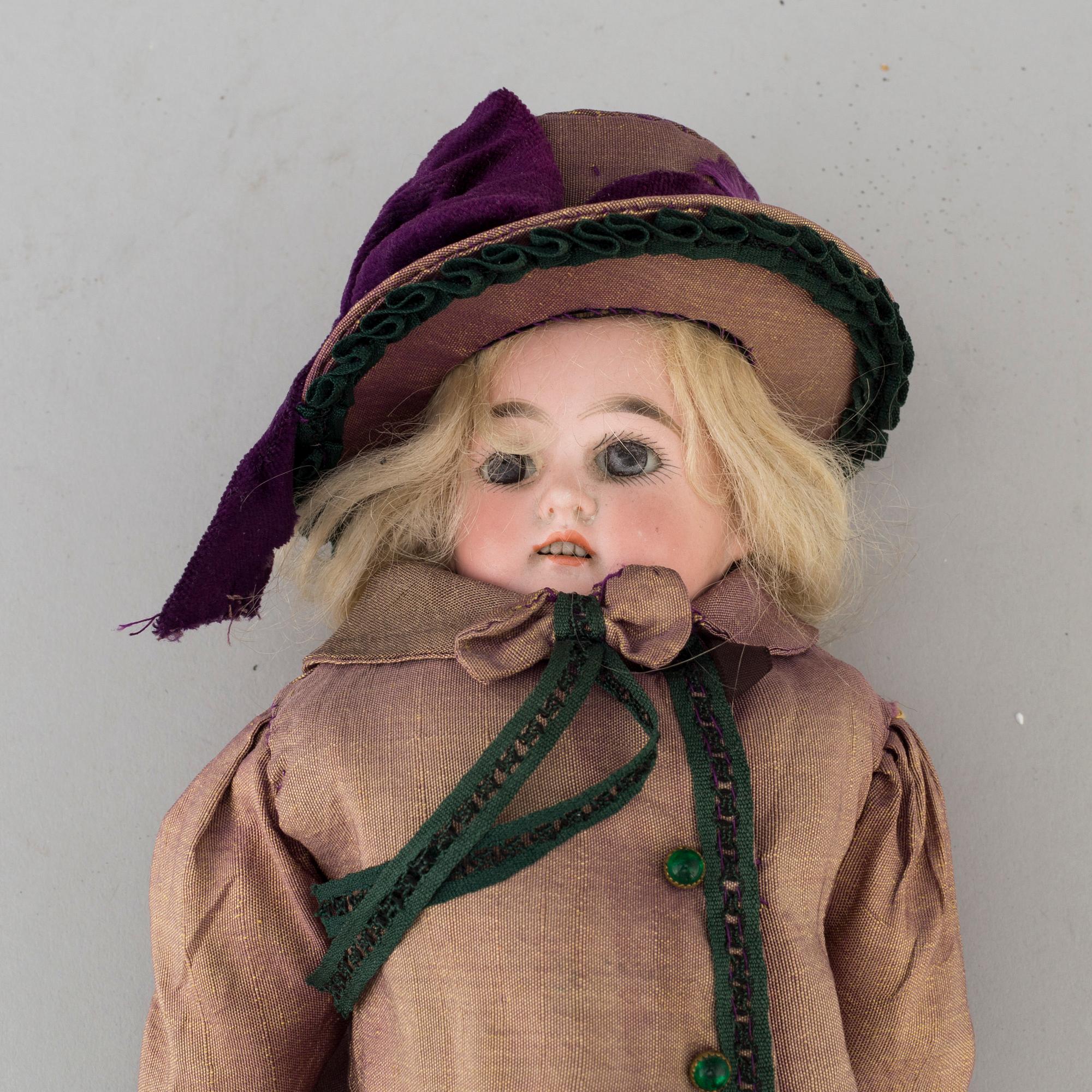 An early 20th cnetury porcelin doll, probably Germany.