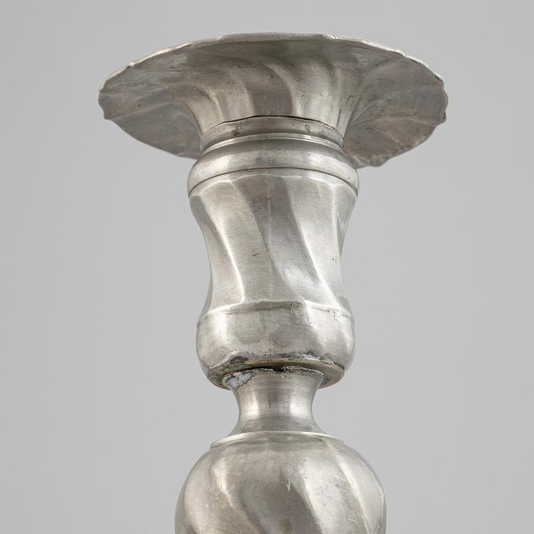 A pair of rococo style pewter candlesticks, 19th Century.
