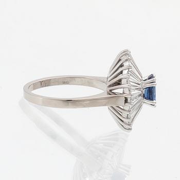 Ring in 18K white gold with an oval faceted sapphire and baguette-cut diamonds.