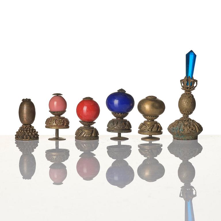 Two boxes with a mandarin's summer hat and black satin autumn hat and feather with six mandarin hat insignias.