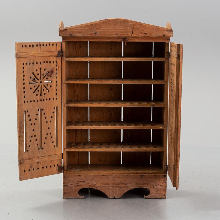 A late 19th century pine cupboard for eggs.