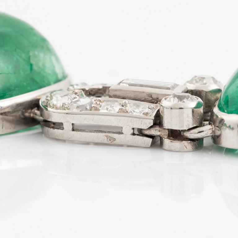 An art deco platinum necklace/bracelet combination with cabochon-cut emeralds.