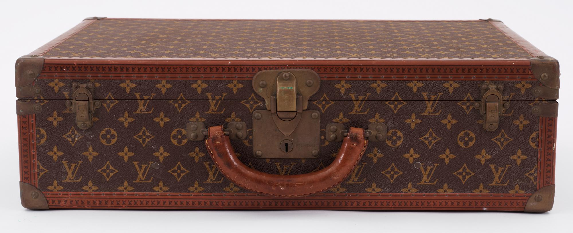 A monogram canvas suitcase by Louis Vuitton.