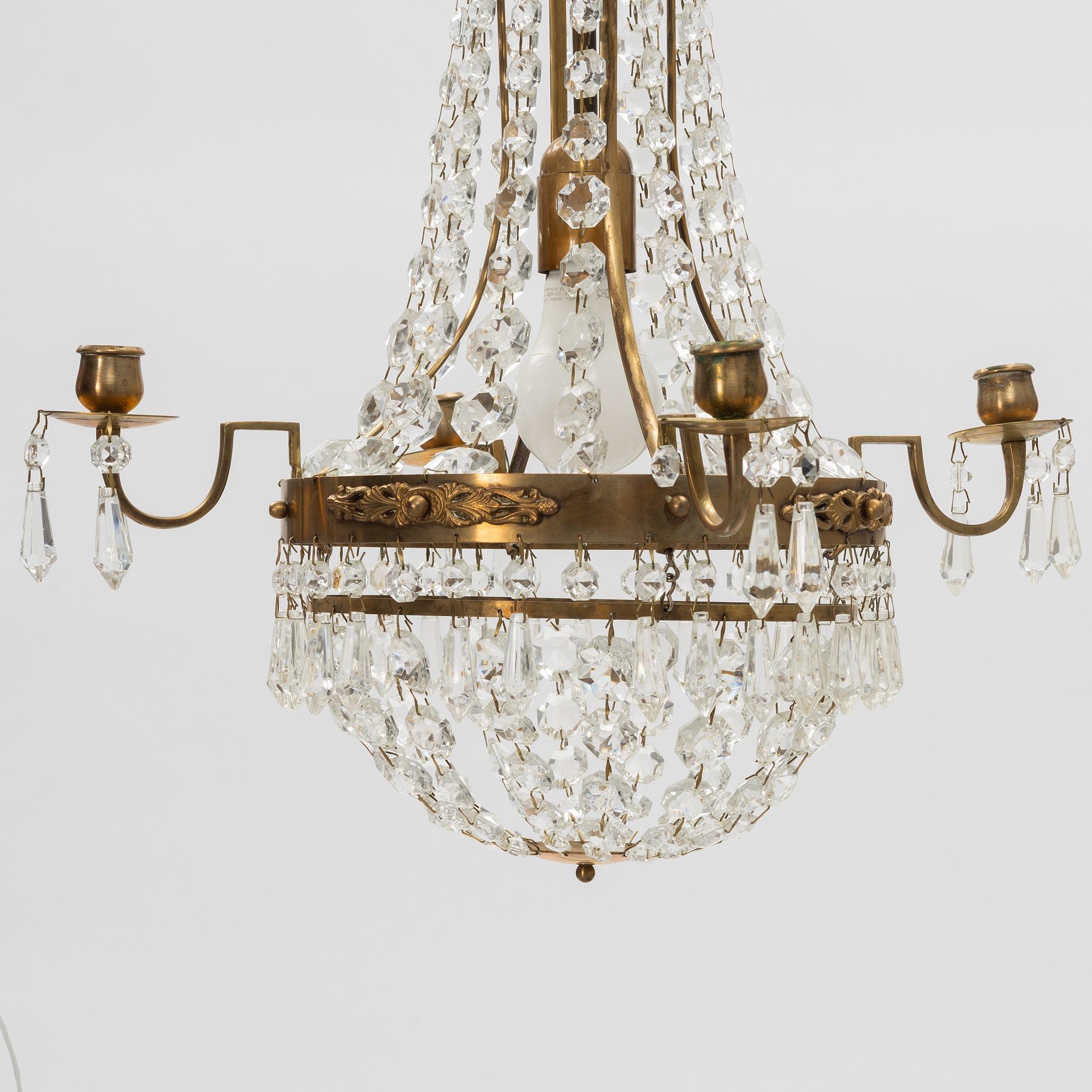 A contemporary matched pair of chandeliers for four candles each.