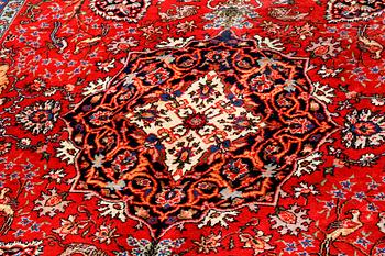An oriental rug, signed, 300 x 202 cm.
